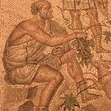 Roman floor mosaic depicting Bacchus holding grapes.