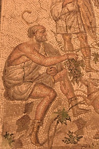 Roman floor mosaic depicting Bacchus holding grapes.